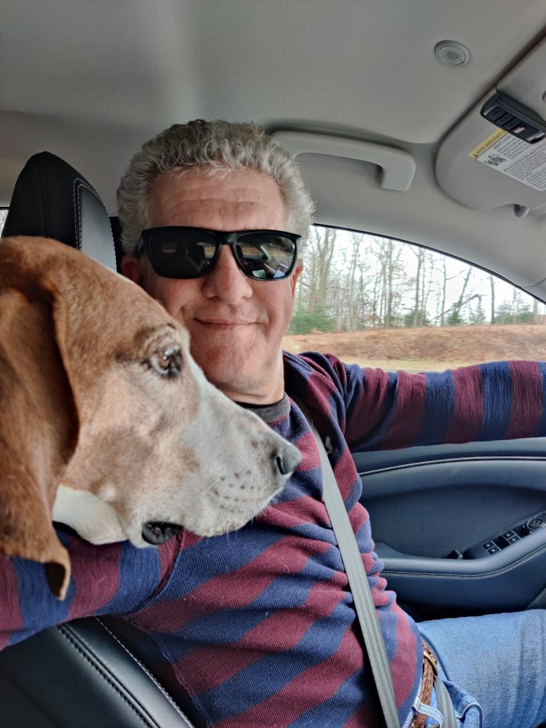 Brad Greene poses for photo with his dog.